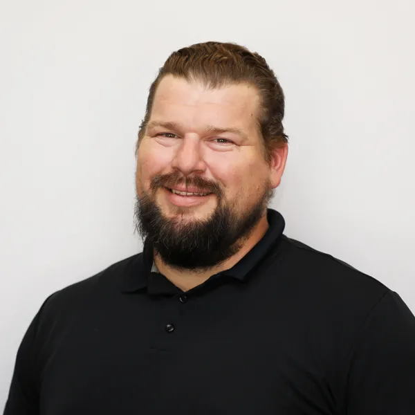 Chase Dube poses for a headshot on a white background.