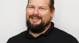 Chase Dube poses for a headshot on a white background.