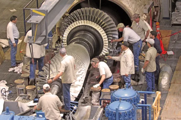 UEM staff work together to operate a turbine.